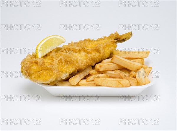 Food, Cooked, Fish, A portion of battered deep fried cod with a slice of lemon and potato chips