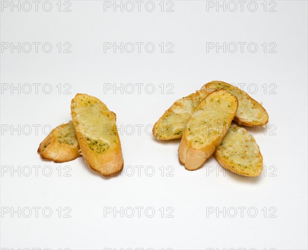 Food, Cooked, Bread, Slices of baguette with melted cheese on a white background.