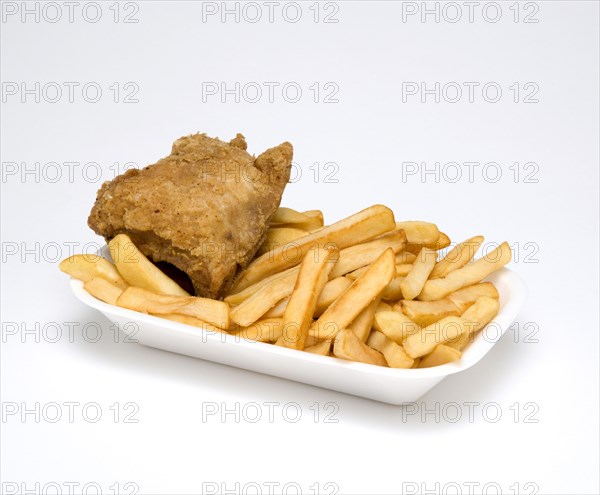 Food, Cooked, Poultry, Single battered chicken breast fillet with potato chips in a polystyrene foam tray on a white background.