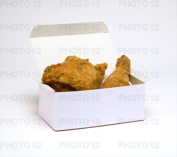 Food, Cooked, Poultry, Battered chicken breast fillet and drumstick in a cardboard box on a white background.