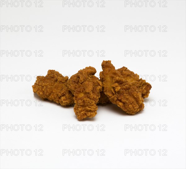 Food, Cooked, Poultry, Battered spicey chicken wings on a white background.