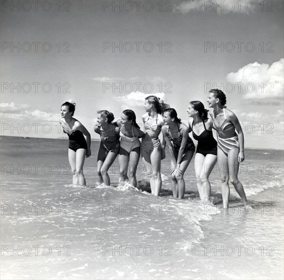 Marquis de Cuevas' company on the beach at Deauville: 7 girls, 7 nationalities