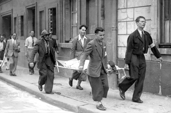 An injured person is transported in the streets of Paris, during the Liberation (August 1944)