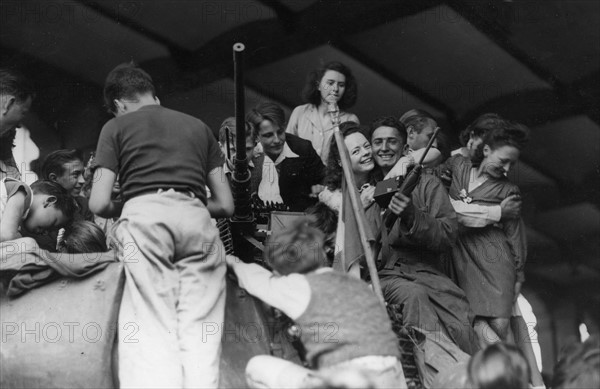 Scene of cheering crowd among French patriots in Paris, during the Liberation (August 1944)