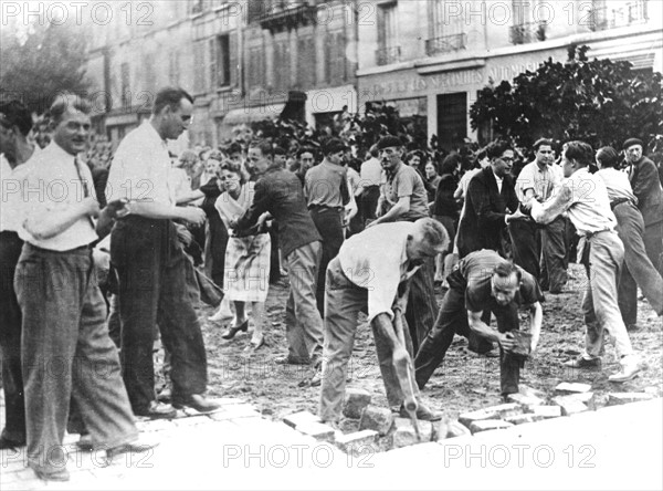 Civilians pulling out cobblestones in the streets, during the Paris uprising (August 1944)