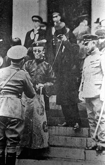 Pu Yi serrant la main d'officiers japonais, vers 1934