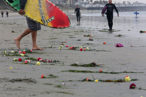 Jan. 18, 2016 - CA, USA - San Diego, CA. January 17, 2016 |    Dozens of surfers and family members of Larry Gordon paddled out Monday at Tourmaline Beach after a memorial on shore attended by more than 400 people. Surf was big, so many opted to stay on shore rather than join the paddle out circle, and lifeguards were standing by on shore and in the water on safety craft.