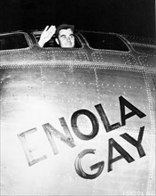 Colonel Paul Tibbets waving from the Enola Gay's cockpit.